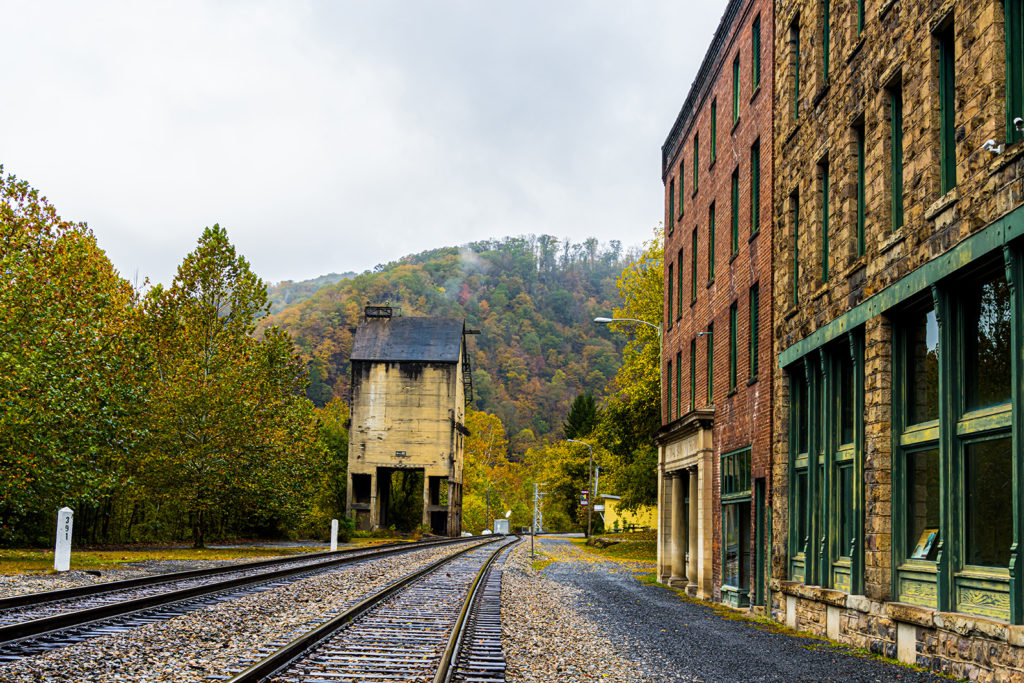 Abandoned stone and brick buildings in downtown Thurmond West Virginia beside railroad tracks New River Gorge National Park 