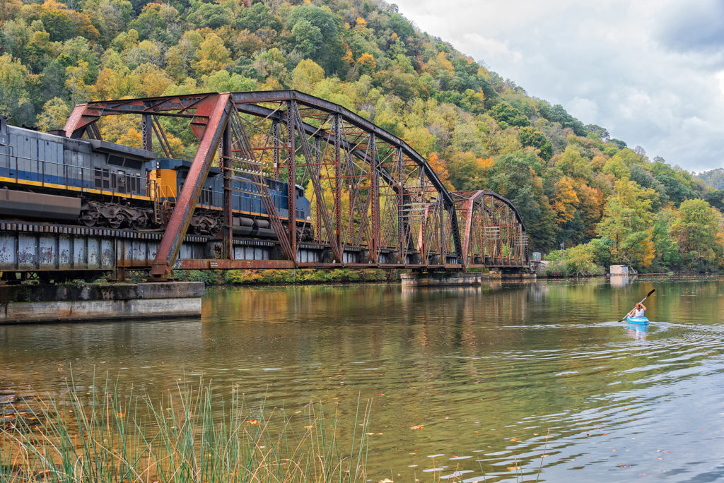 Railroad trestle with train on a fall day at Hawks Nest State Park New River Gorge National Park West Virginia