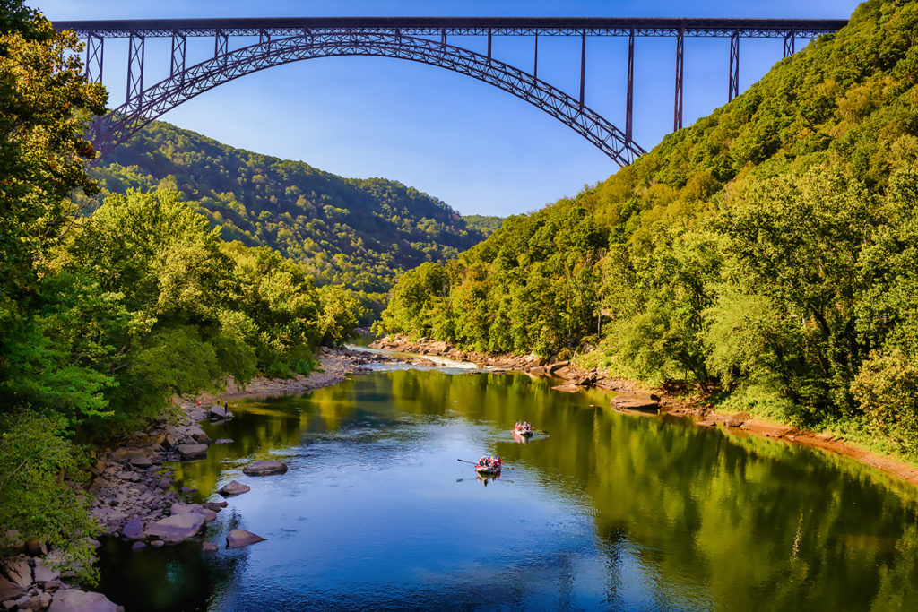 Two rafts on the New River under the New River Gorge bridge whitewater rafting the Lower New River