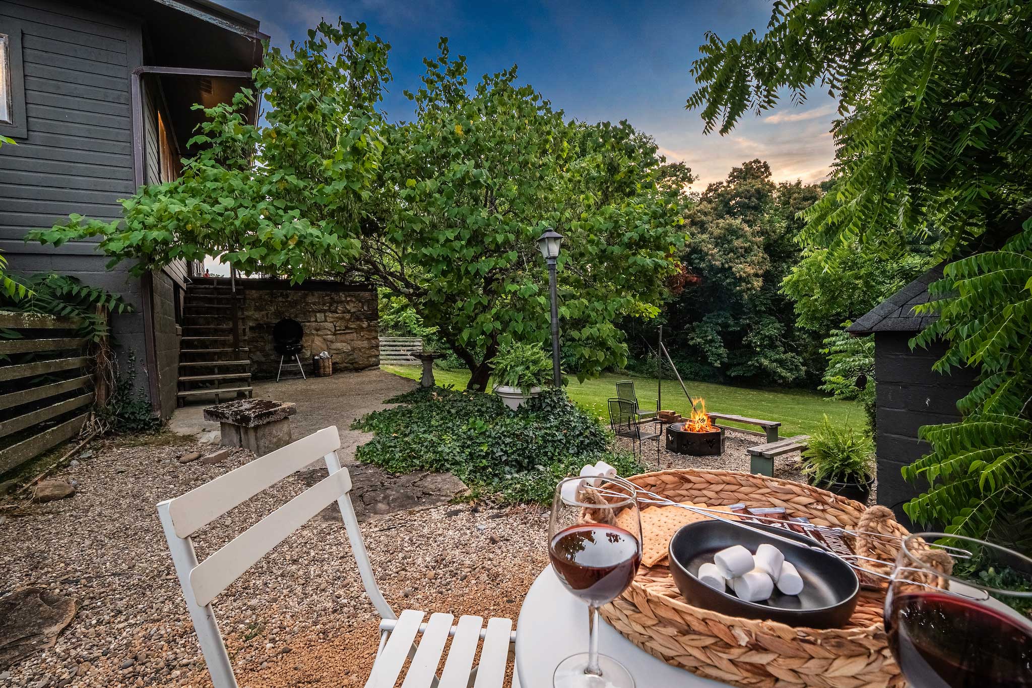 Evening patio with wine glasses and fire