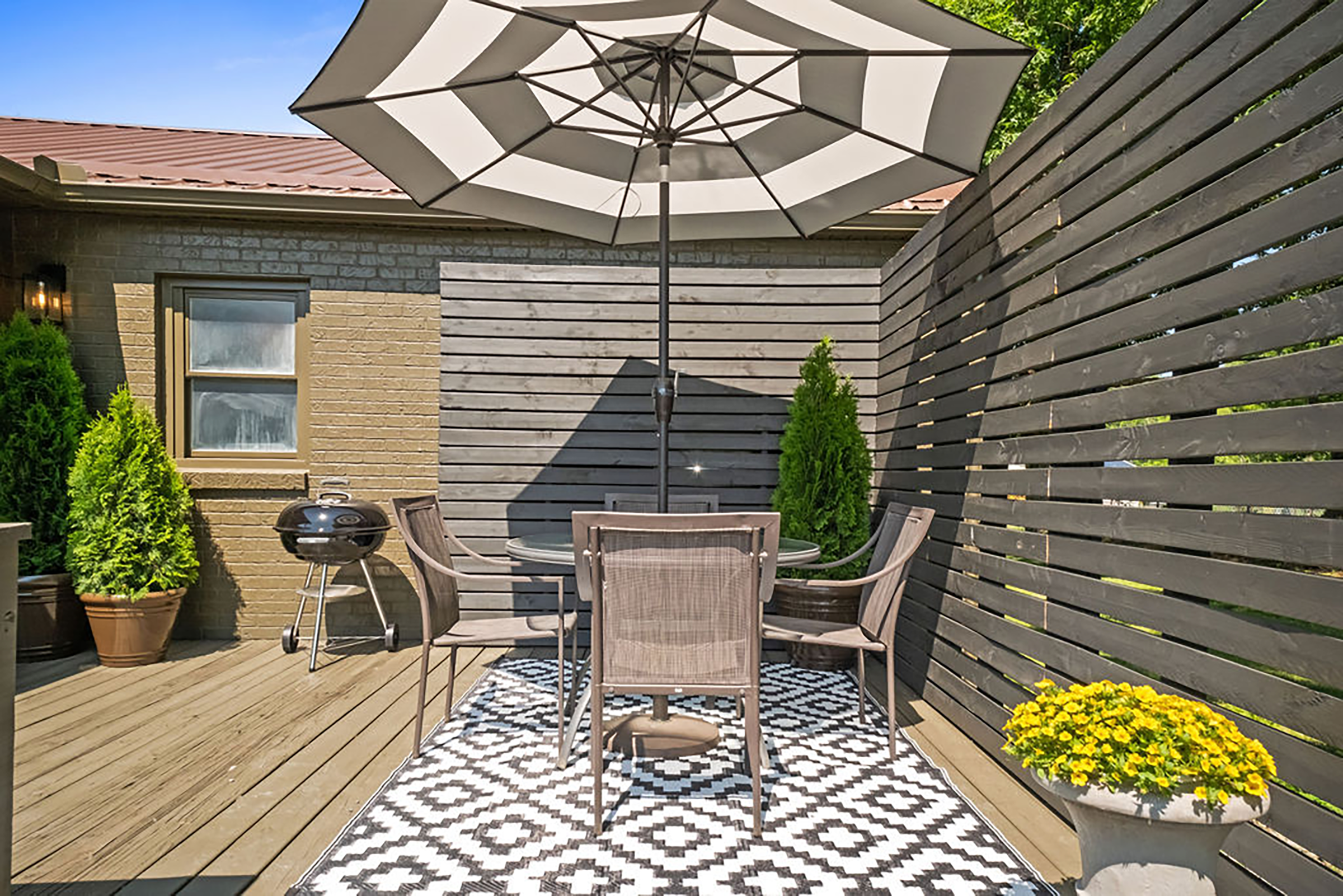 Adventure Haven covered deck with patio seating — outdoor living at Ames Heights WV